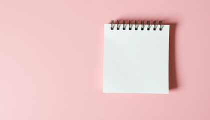 Blank notepad on pink background