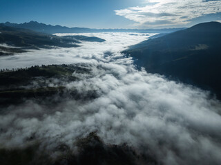 Aerial view of beautiful high altitude snow capped mountains and forest grassland landscape in China