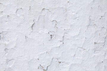 The wall is covered in white paint and has a rough texture
