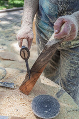Man is cutting wood with a saw