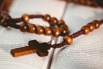 Rosary beads on open bible pages