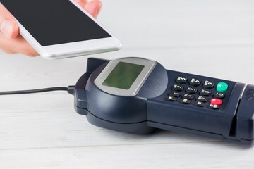 Man using smartphone to express pay