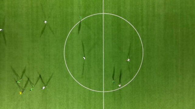 Aerial view of soccer match on turf field, Pakistan.