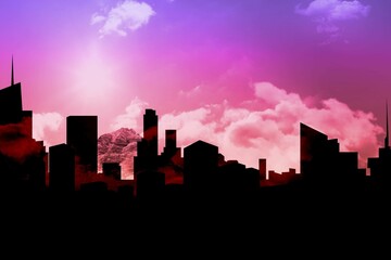 Fototapeta premium Composition of black cityscape over mountains and clouds with blue sky