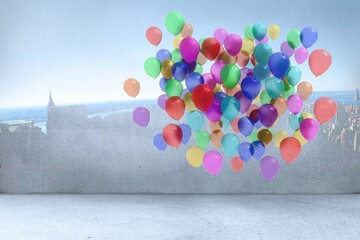 Fototapeta premium Many colourful balloons in room with city on wall