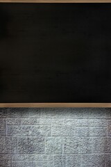 Flat design blackboard is being shown on textured stone block wall featuring wooden frame