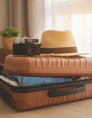 Close up suitcases and travel essentials being packed into bags.