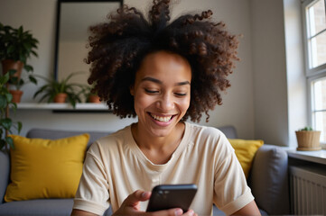 A woman sitting on a couch looking at her phone.