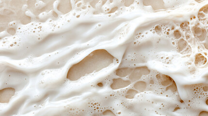 Abstract water texture with faint ripples and a creamy white surface 