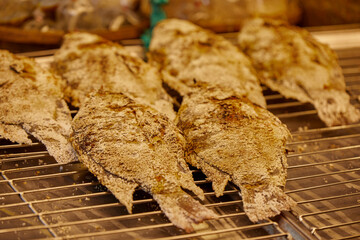 Close-up of salt crusted grilled Tilapia fish on barbecue grill