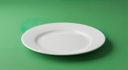 Empty white plate isolated on green and white backgrounds for food and kitchen themes