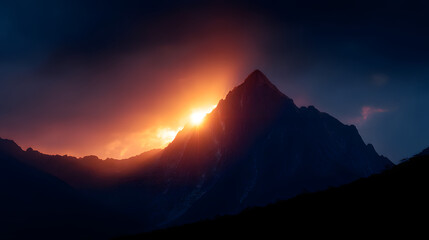 Fototapeta premium Mountain Majesty: A majestic mountain peak silhouetted against a dramatic, golden sunset, a landscape masterpiece.