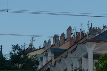 Obraz premium A picturesque row of charming houses, each adorned with prominent chimneys rising gracefully from their rooftops, creating a quaint skyline