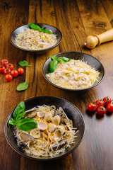 Delicious seafood pasta served on elegant black bowls garnished with herbs