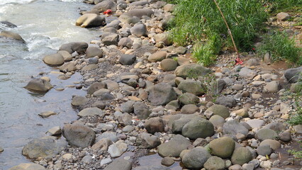 Piles of river stones on the edge of a river