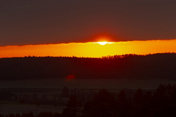 As the sun slowly descends towards the horizon, it casts beautiful hues of orange and yellow across...