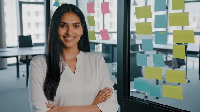 Confident professional planning with ideas on sticky notes in modern office setting