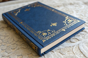 Blue Book with Gold Accents on a Textured Surface