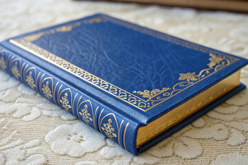 Blue Book with Gold Accents on a Textured Surface