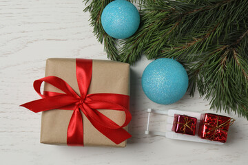 Gift boxes, New Year toys, New Year tree on white wood