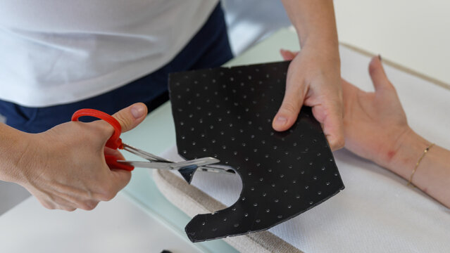 Medical therapist adjusting a hand splint for a girl in a rehabilitation clinic