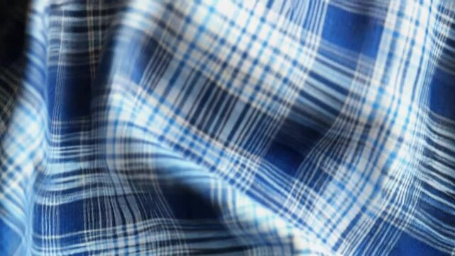 Blue checkered fabric flowing and forming elegant folds