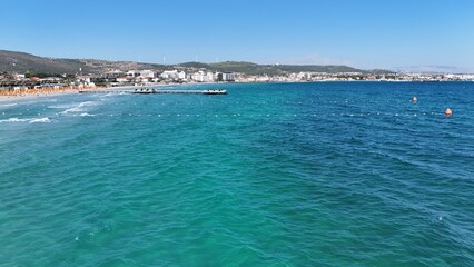 Fototapeta premium Aerial view of a scenic pier stretching into the turquoise sea