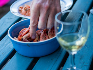 Cropped Hand Taking Shrimp From Bowl