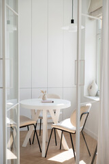 Modern Minimalist Dining Area with White Table and Chairs