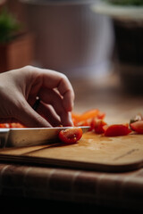 Close-up of hands cutting cherry tomatoes