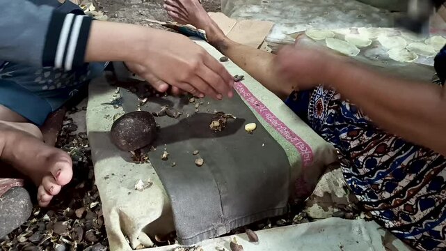 pounding melinjo fruit, the process of making emping chips