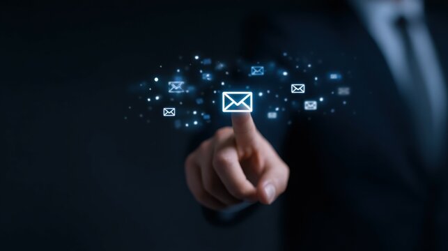 A man is pointing at a screen with a blue envelope on it