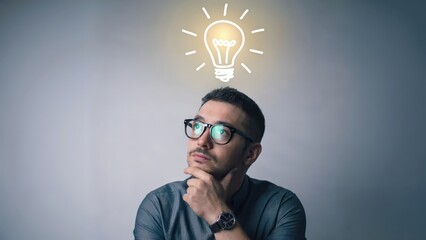 Man is thinking with a lightbulb above, concept of idea and innovation