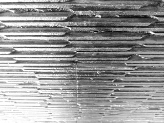 Close-Up Texture of Stacked Welded Metal Plates in Black and White