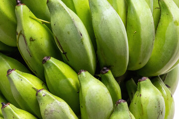 Close-up of fresh green bananas, ideal for a healthy diet. A natural and nutritious food choice.