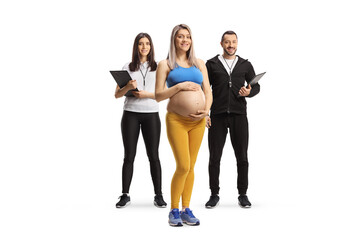 Fototapeta premium Pregnant woman with a male and female fitness trainers