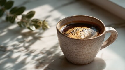 Creamy Coffee in Beige Cup on Marble Surface with Sunlight