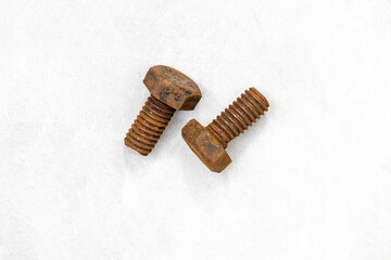 A pair of very old rusty iron bolts, no nuts, isolated on white. Corroded vintage metal texture.