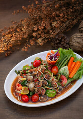 Spicy Thai Seafood Salad with Cockle on White Plate