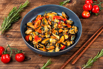 Plate of mussels on a table.