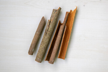 Natural cinnamon sticks (Cinnamomum zeylanicum) on a wooden background, captured from a top view. Delicious spice for cooking and baking concepts.