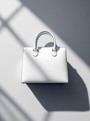 A white leather handbag with handles sitting on a white surface with window shadow patterns behind it