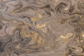 Abstract acrylic fluid texture in beige tones and golden splashes