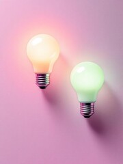 Two light bulbs glowing with different colors on a pink background in a vertical composition view
