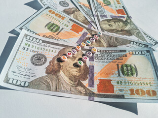 Concept image of emergency fund with dollar bills and colorful alphabet beads

