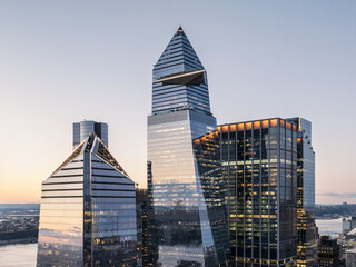 Aerial view of striking modern skyscrapers piercing the skyline with their geometric designs and reflective glass facades, 130 William Street, New York, New York, United States.