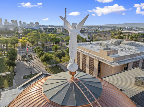 Aerial view of the copper-clad dome of the Arizona State Capitol crowned by Winged Victory gleams against the Phoenix skyline, Phoenix, Arizona, United States.