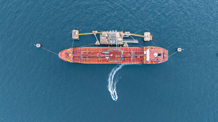 Aerial view oil ship tanker vessel loading and unloading in oil terminal station refinery, Global...
