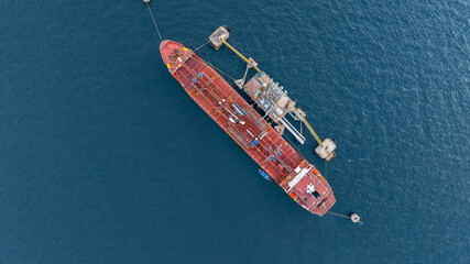 Aerial view oil ship tanker vessel loading and unloading in oil terminal station refinery, Global...