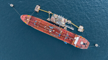 Aerial view oil ship tanker vessel loading and unloading in oil terminal station refinery, Global...